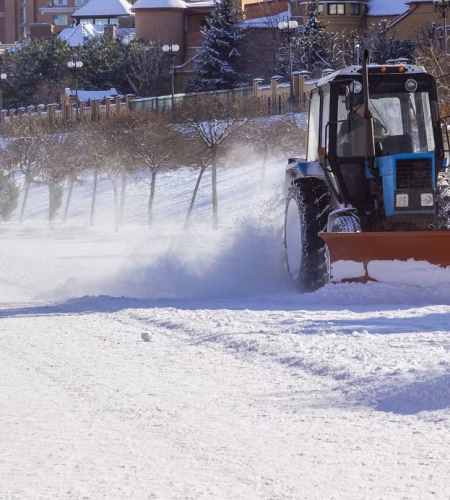 Snow removal machine clears the way in a cottage town after heavy a snowfall. Snow clearing.